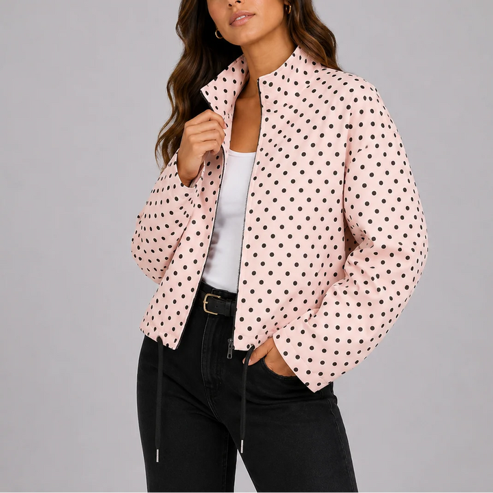 Woman styling navy polka dot bomber jacket with black jeans for casual everyday look
