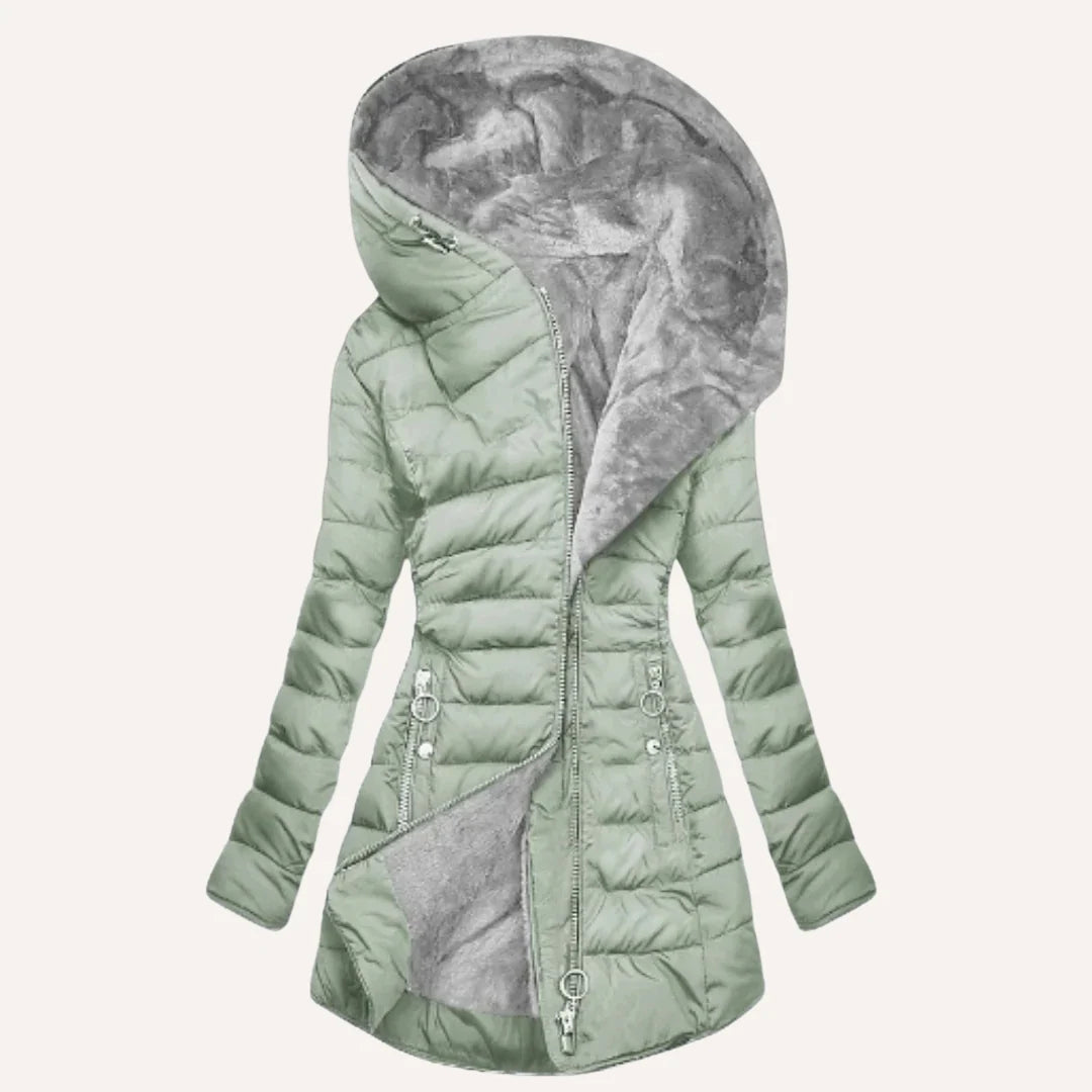 Close-up of zip pocket detail on women's quilted puffer jacket hip area