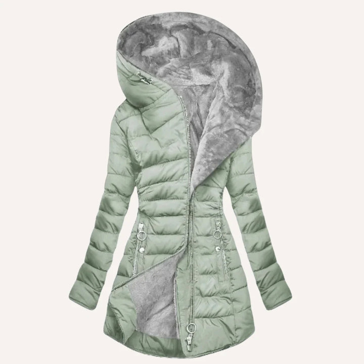 Close-up of zip pocket detail on women's quilted puffer jacket hip area