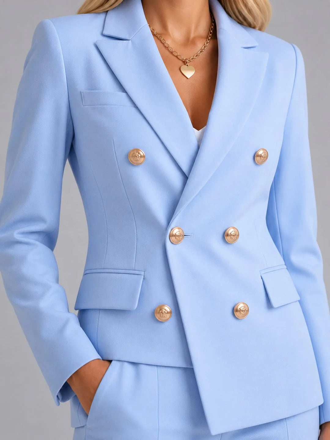 Front view of women's structured blazer and matching tailored trousers in light blue fabric