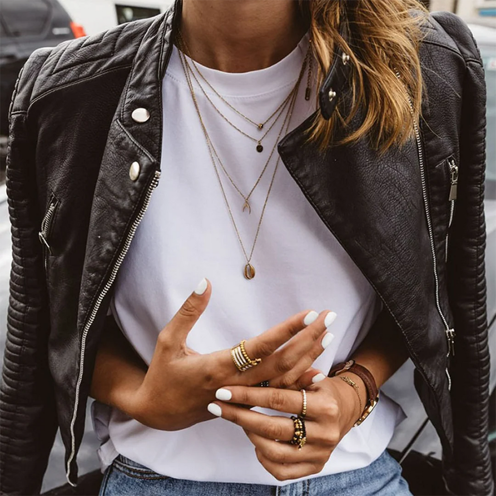 Side view of women's biker jacket with structured shoulders and zippered pockets