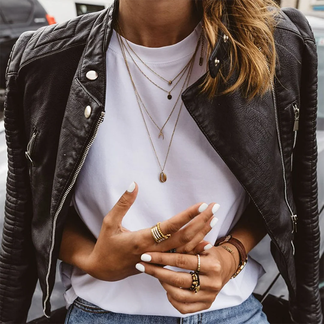 Side view of women's biker jacket with structured shoulders and zippered pockets