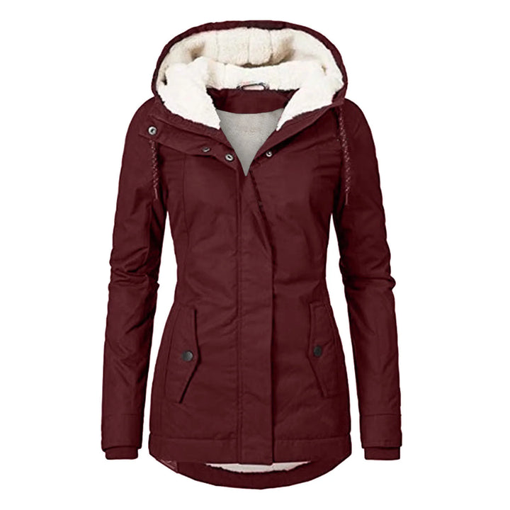 Close-up view of women's hooded parka showing fleece lining and curved hem silhouette detail