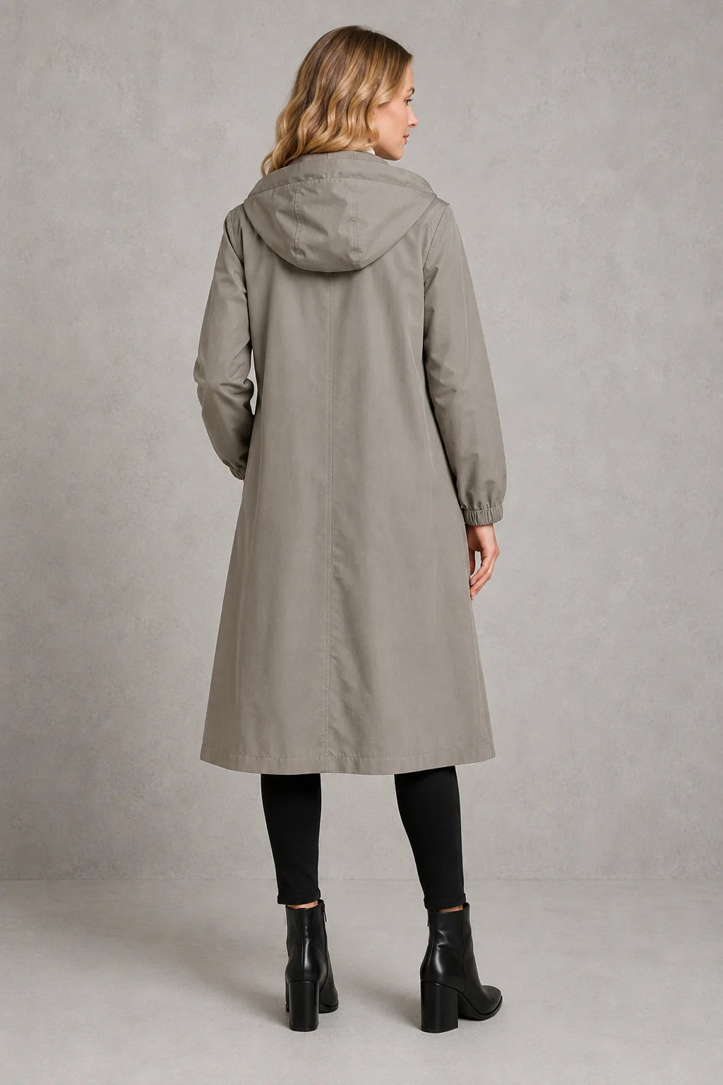 Longline hooded trench coat showing elasticated cuffs and water-repellent finish in neutral grey tone