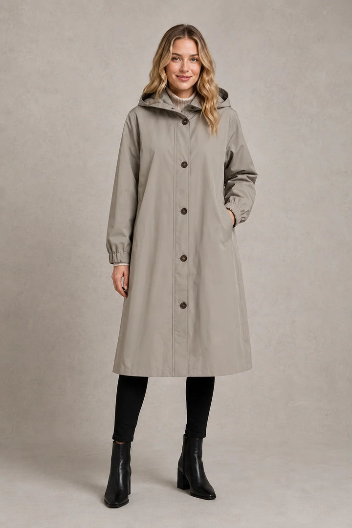 Side view of hooded trench coat displaying longline length and relaxed oversized silhouette