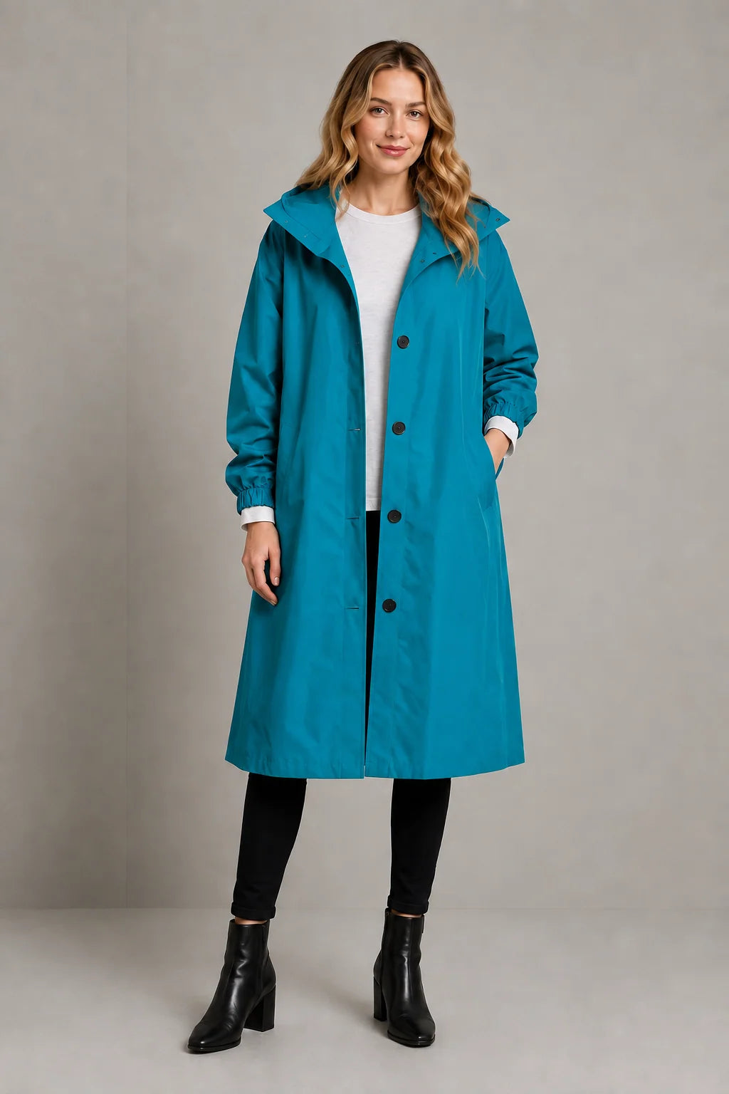 Detail of double-breasted button closure and elasticated cuffs on women's trench coat
