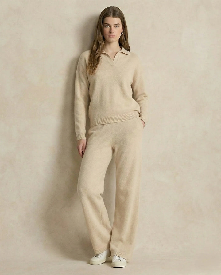Woman seated in beige Merino lounge set with polo collar jumper and tapered trousers
