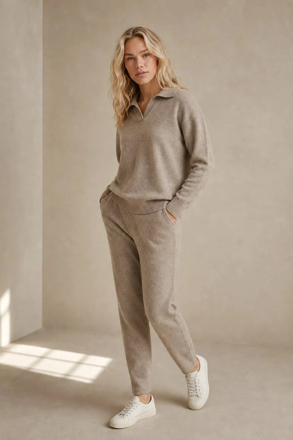 Side view of woman in beige knit Merino lounge set with relaxed fit jumper and tapered trousers