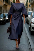 Side view of midi dress showing flowing skirt and wide kimono sleeve detail