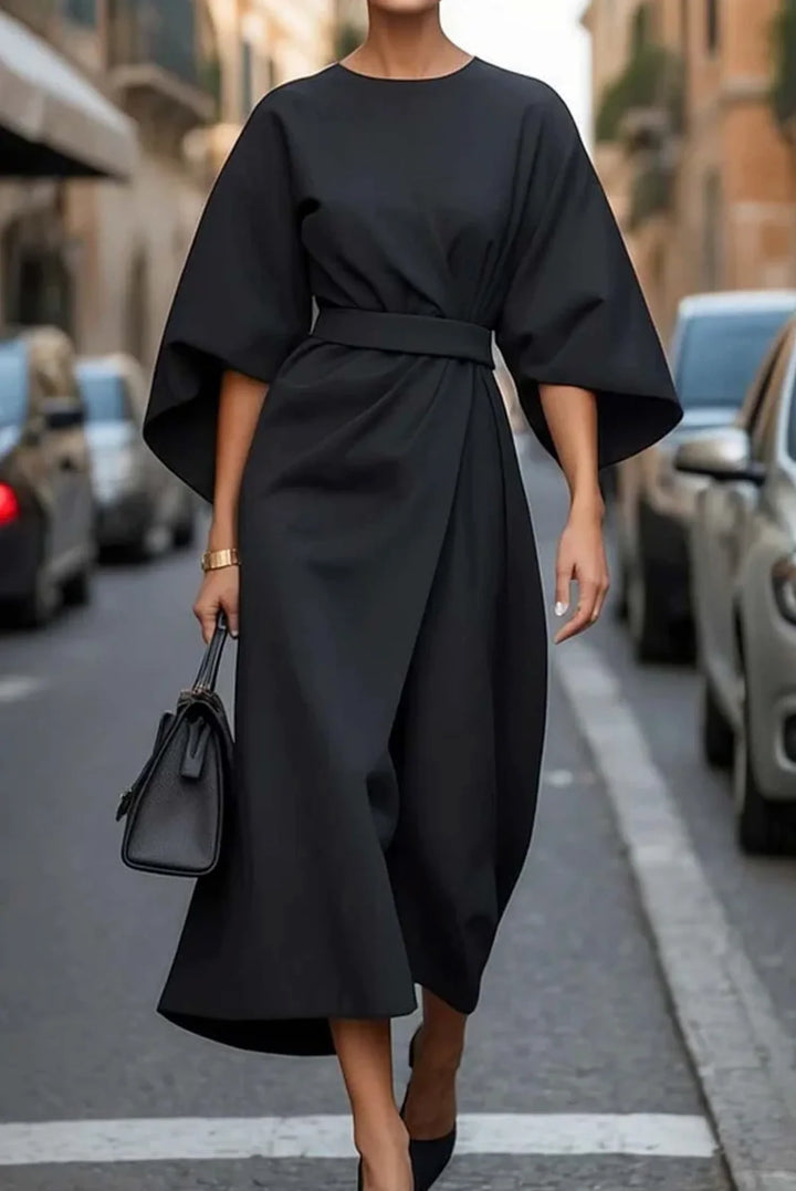 Back view of midi dress with kimono sleeves and mid-calf length flowing skirt