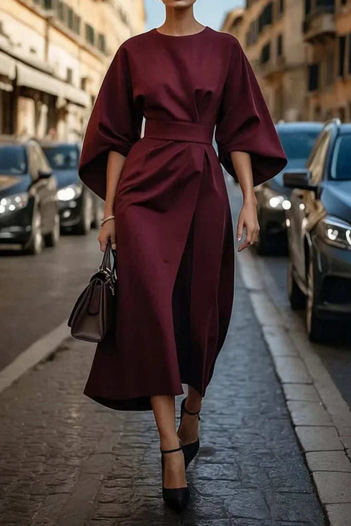 Model wearing midi dress with kimono sleeves styled for formal evening event