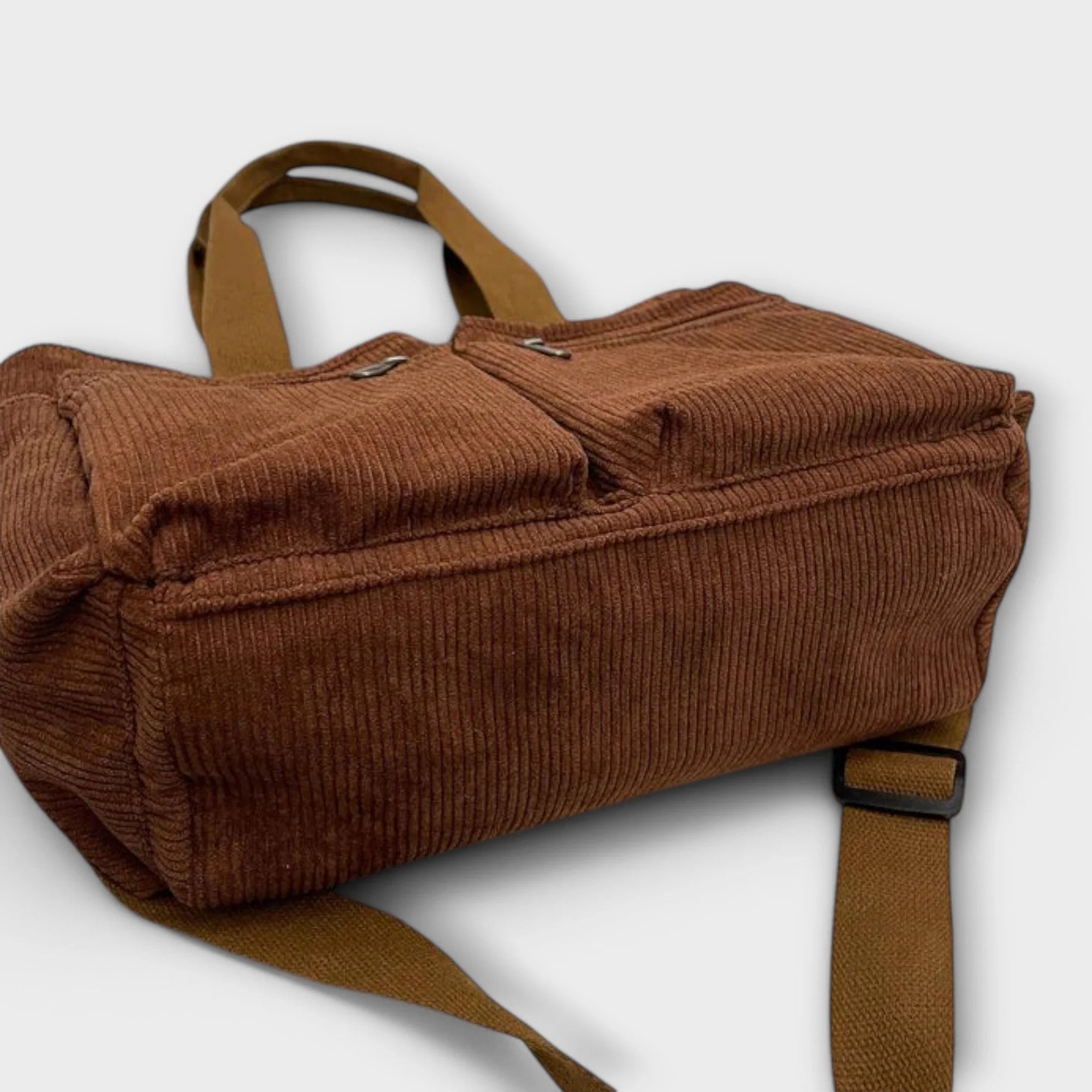 Women's corduroy tote bag showing zip compartments and structured shape