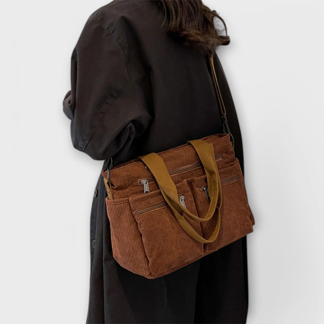 Side profile of brown corduroy tote bag with adjustable shoulder strap
