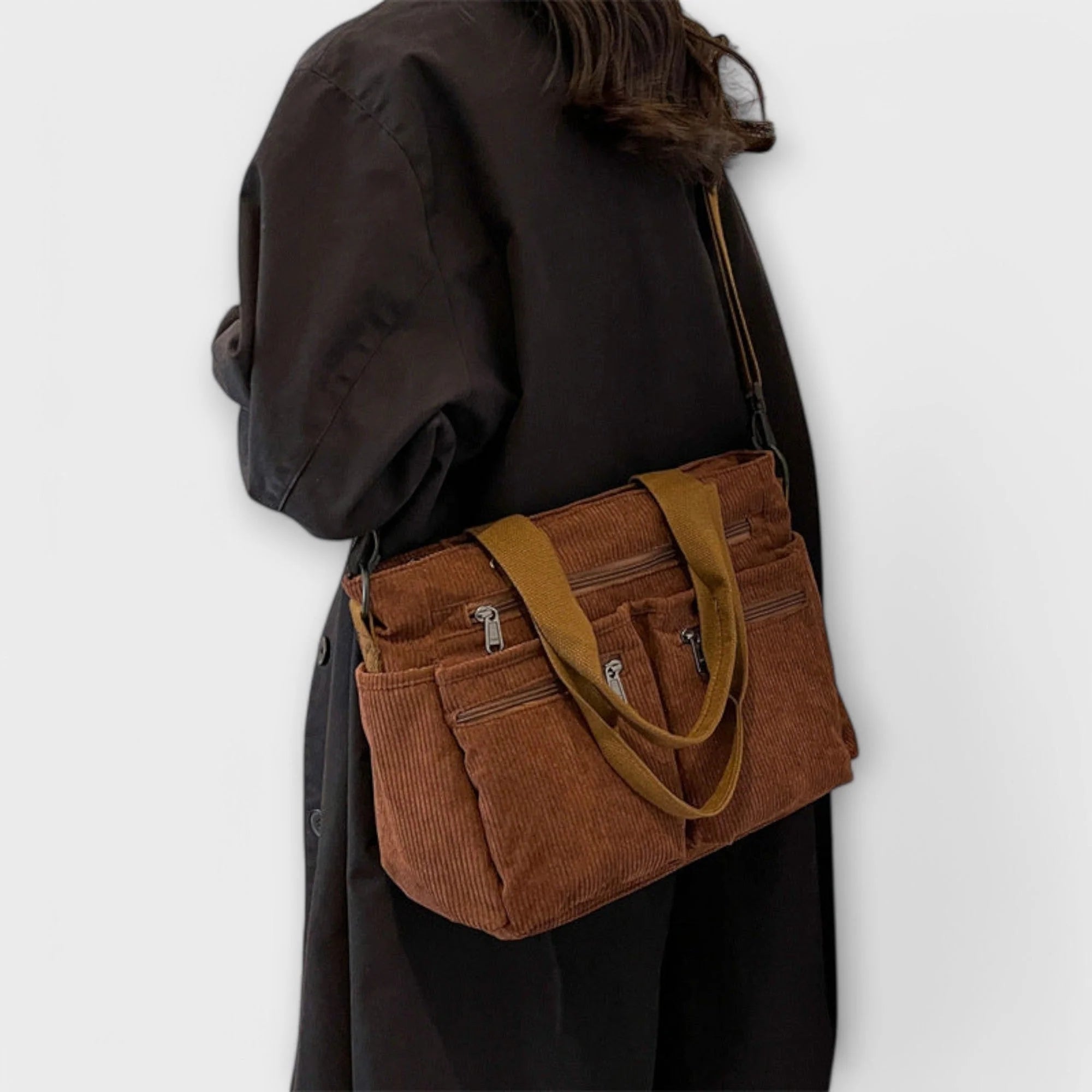 Side profile of brown corduroy tote bag with adjustable shoulder strap