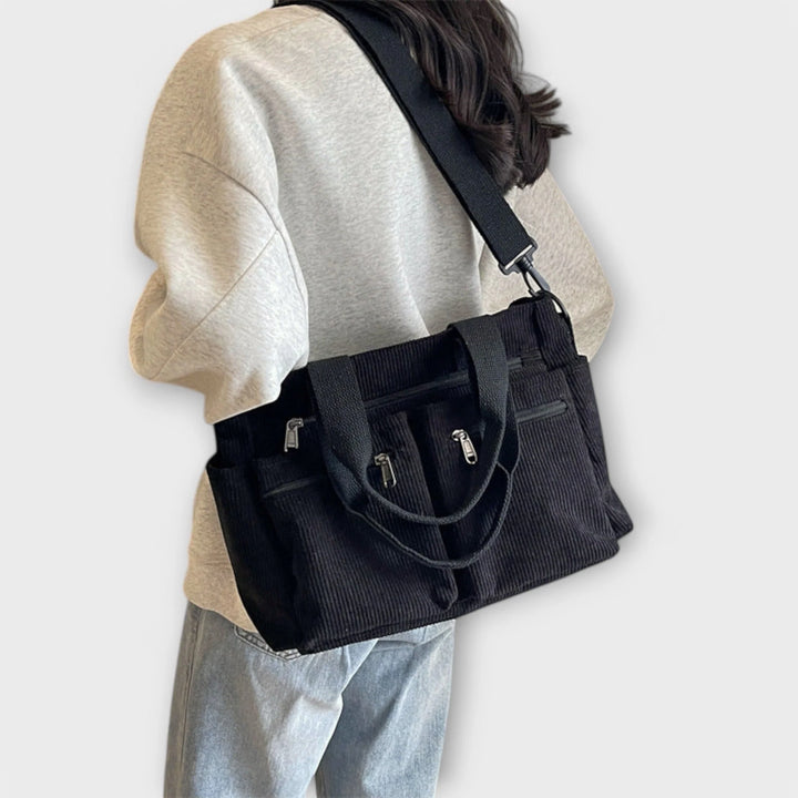Front pocket detail on women's corduroy tote bag with zip closures