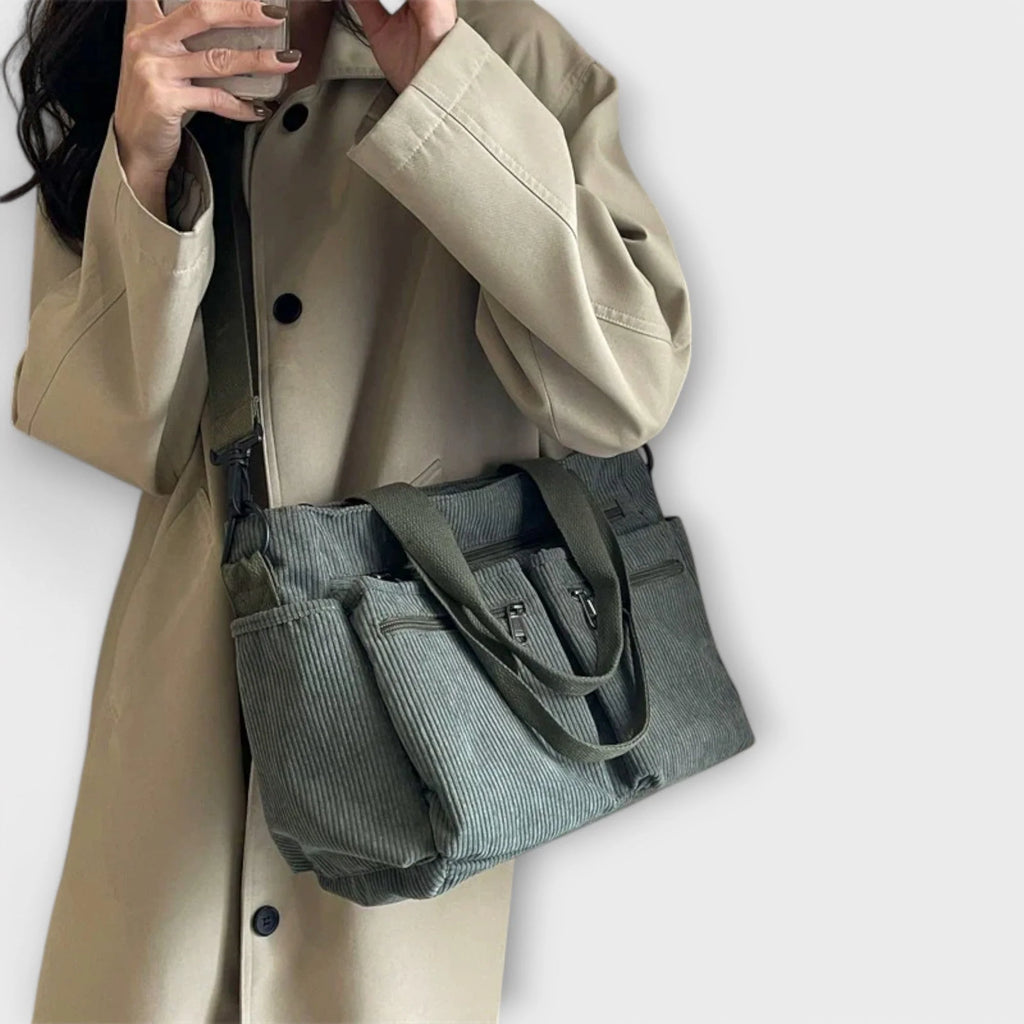 Women's corduroy tote bag showing dual carry options with handles and strap