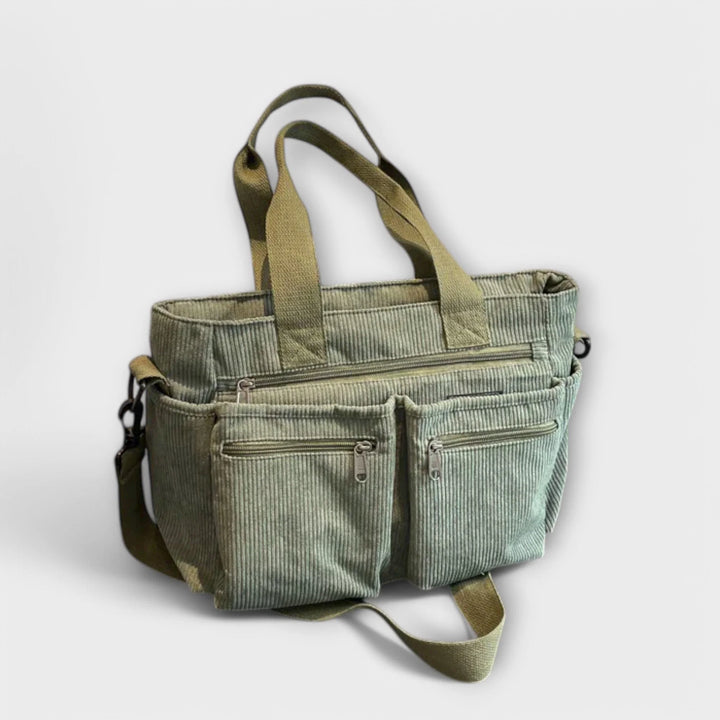 Detail of adjustable shoulder strap on brown corduroy tote bag