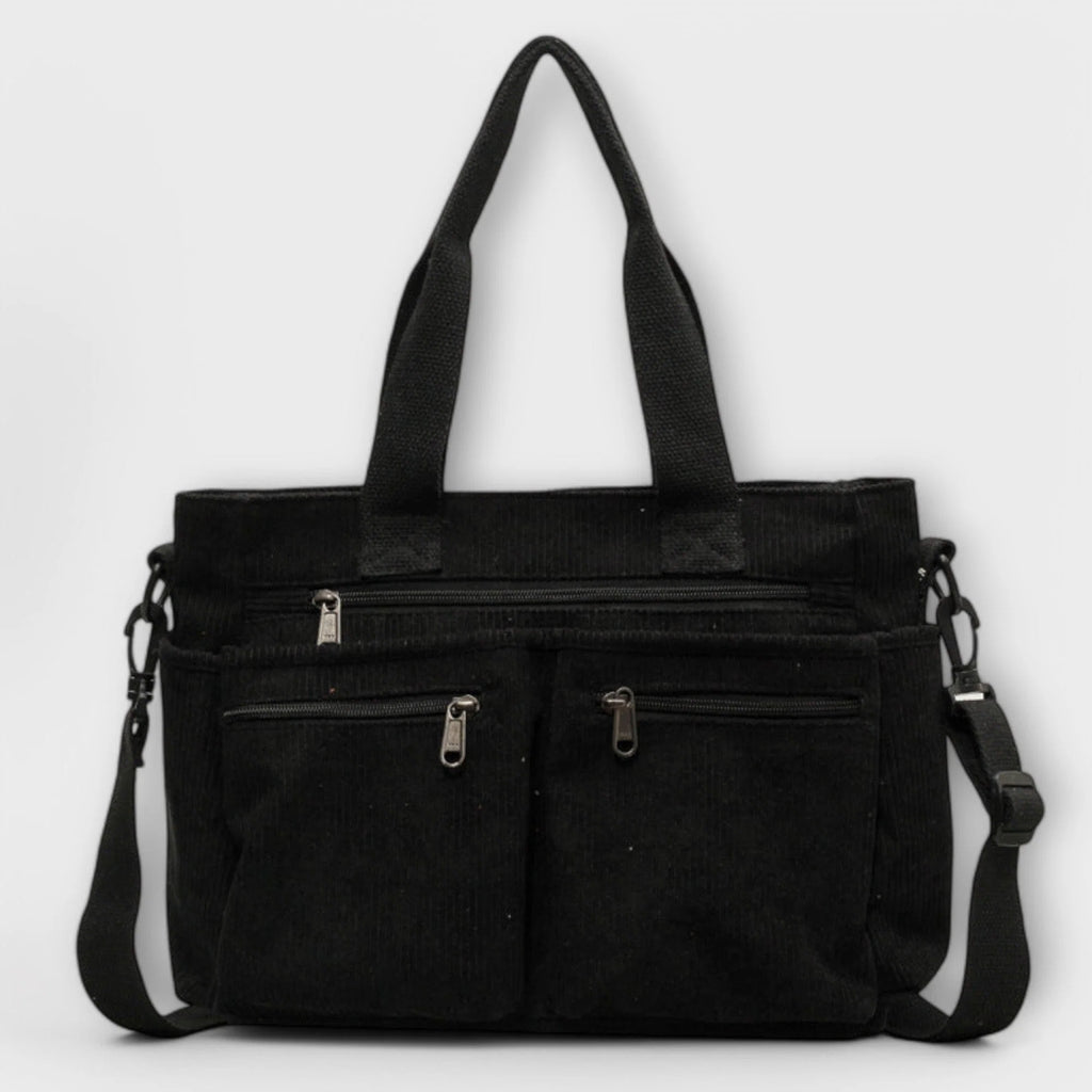 Side view of women's corduroy tote bag highlighting textured ribbed fabric and shoulder strap