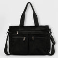 Side view of women's corduroy tote bag highlighting textured ribbed fabric and shoulder strap