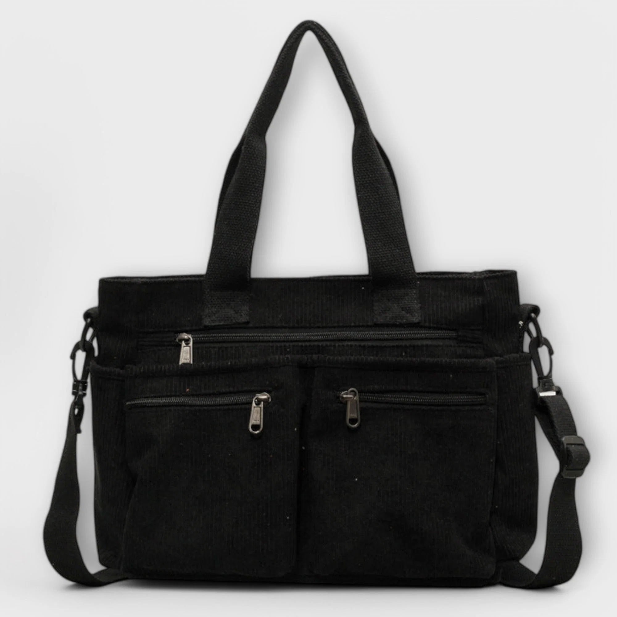 Side view of women's corduroy tote bag highlighting textured ribbed fabric and shoulder strap