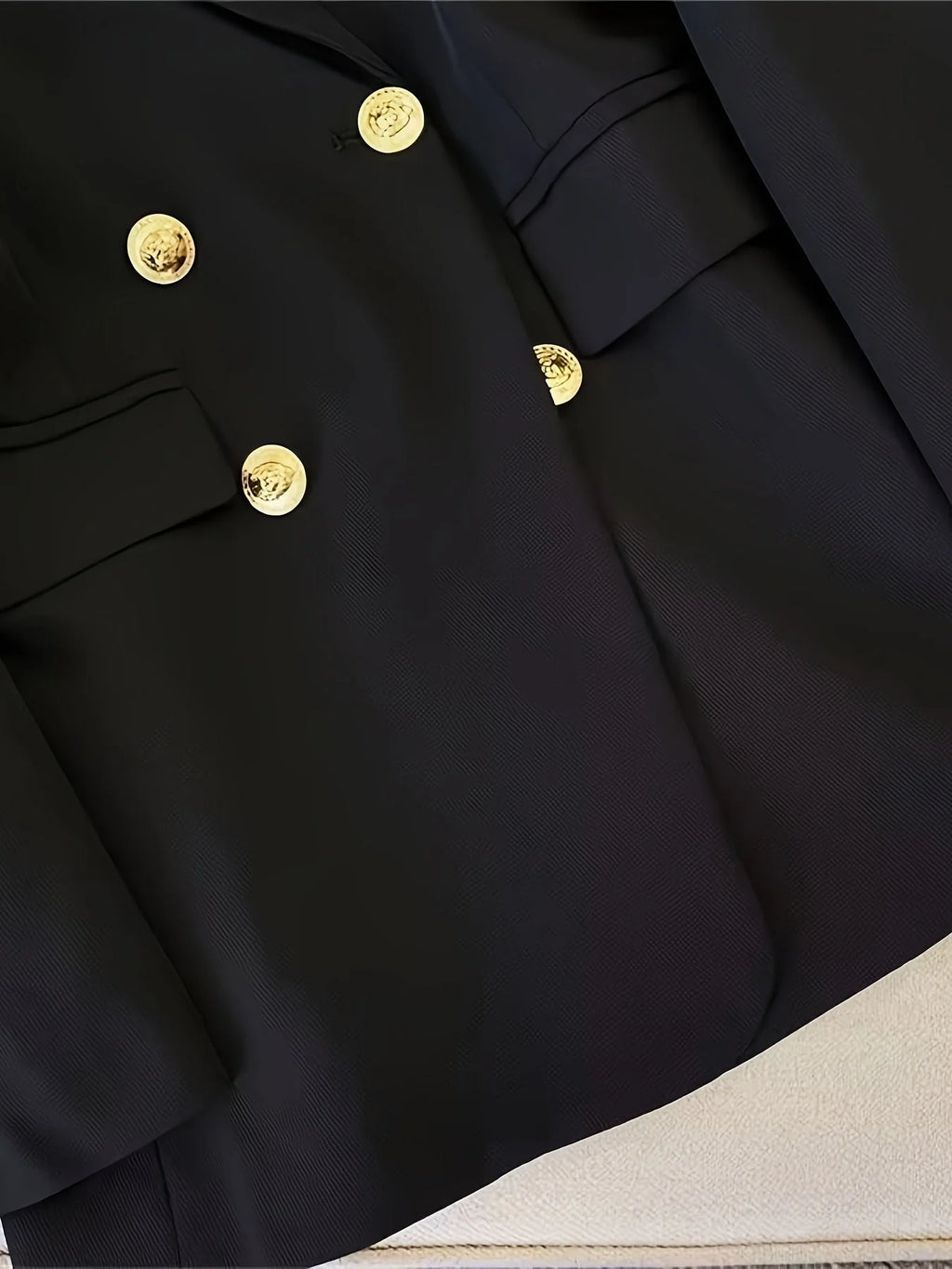 Front view of black tailored blazer with flap pockets and chest welt pocket detail