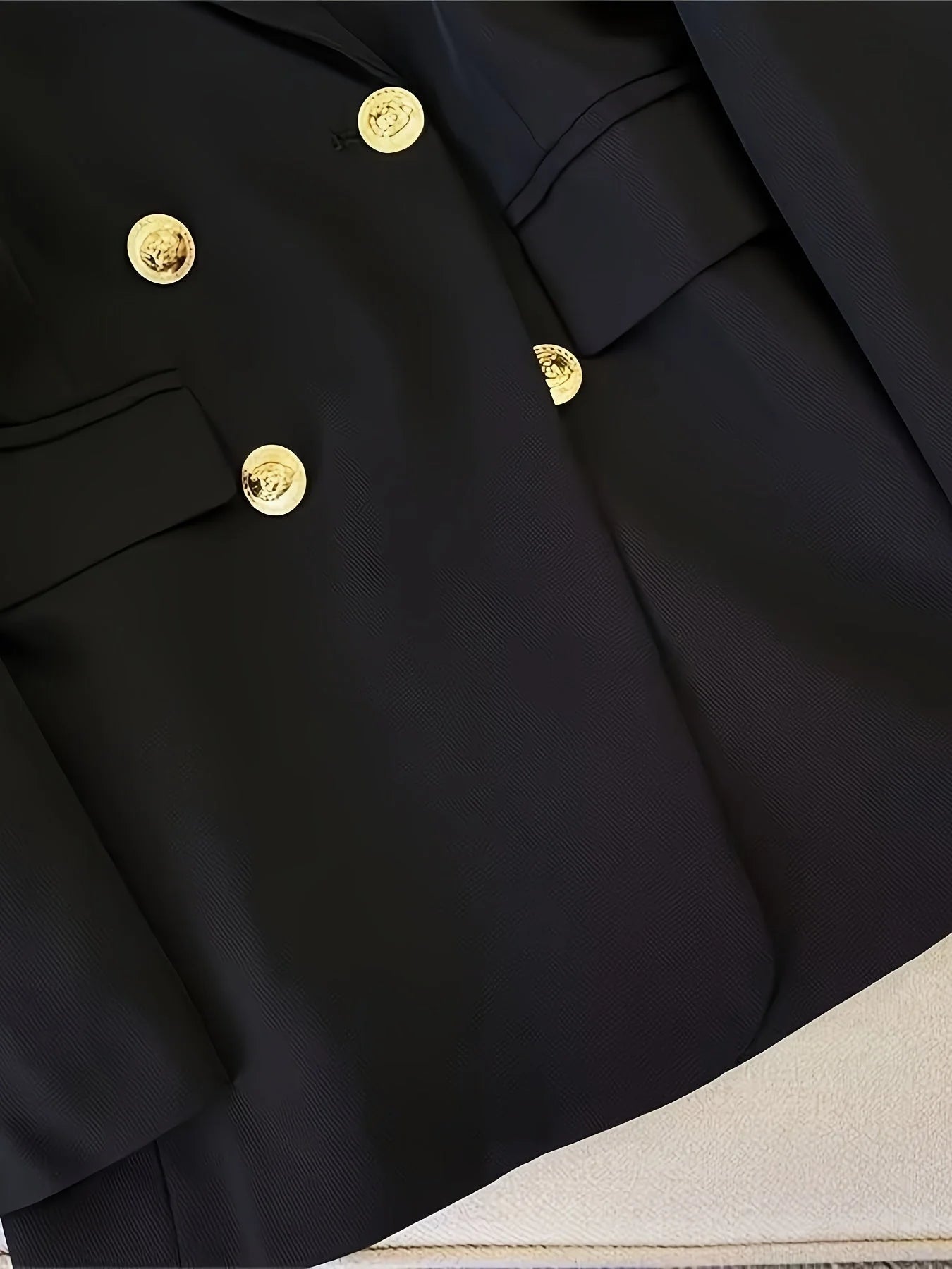 Front view of black tailored blazer with flap pockets and chest welt pocket detail