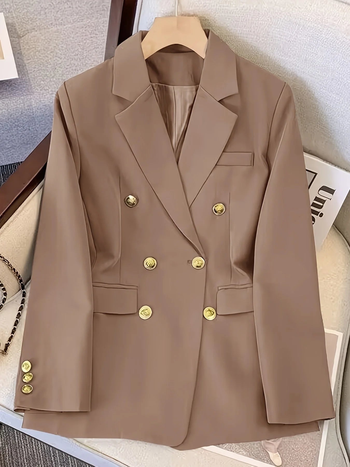 Close-up of blazer pocket detailing showing flap pockets and welt chest pocket