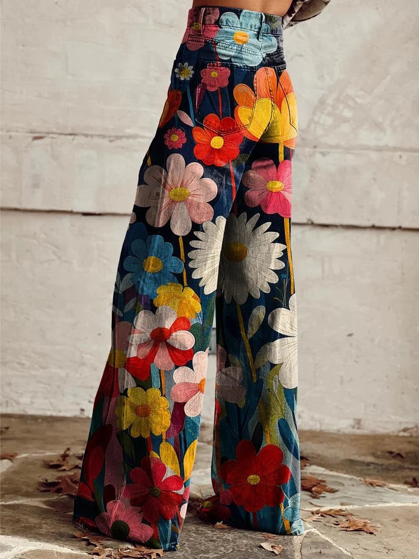 Close-up view of floral print wide-leg trousers showing vibrant daisy pattern and structured fabric drape