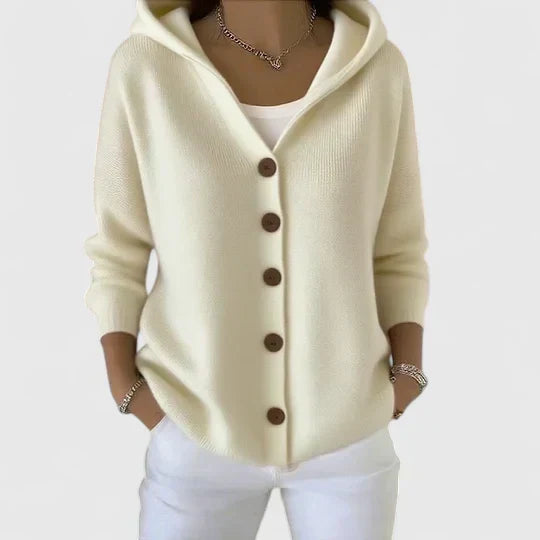Women's hooded cardigan paired with white trousers for casual layered look