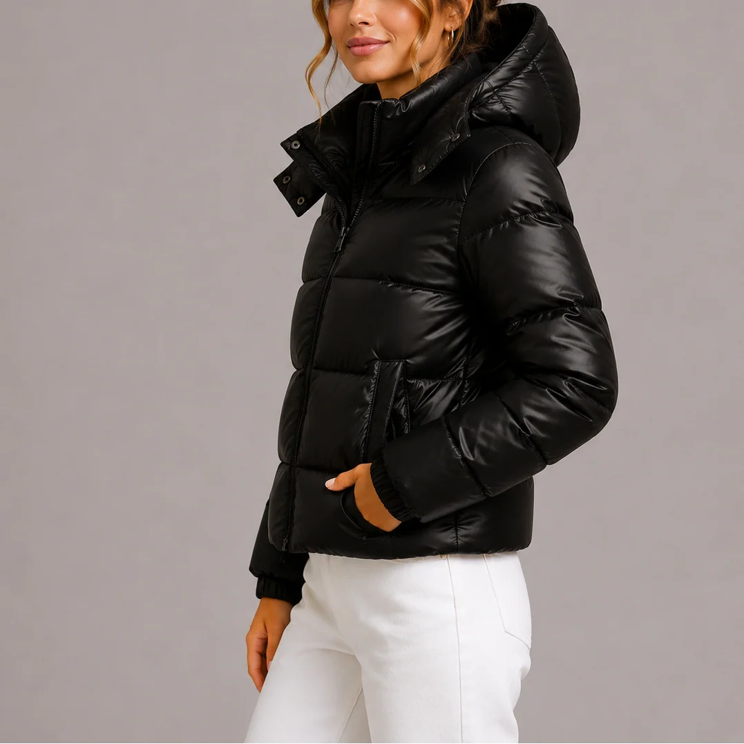 Close-up of women's puffer jacket hood and full-zip closure detail in navy