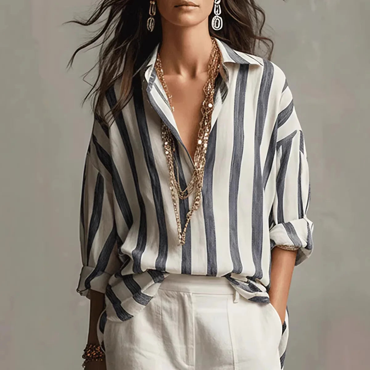 Women's relaxed-fit striped linen shirt with open collar and long sleeves styled with white trousers