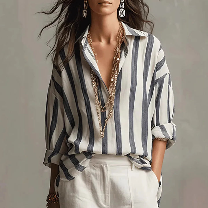 Women's relaxed-fit striped linen shirt with open collar and long sleeves styled with white trousers