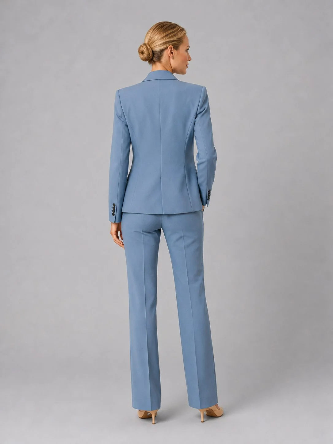 Side angle of women's tailored suit set displaying structured blazer fit and straight-leg trouser silhouette