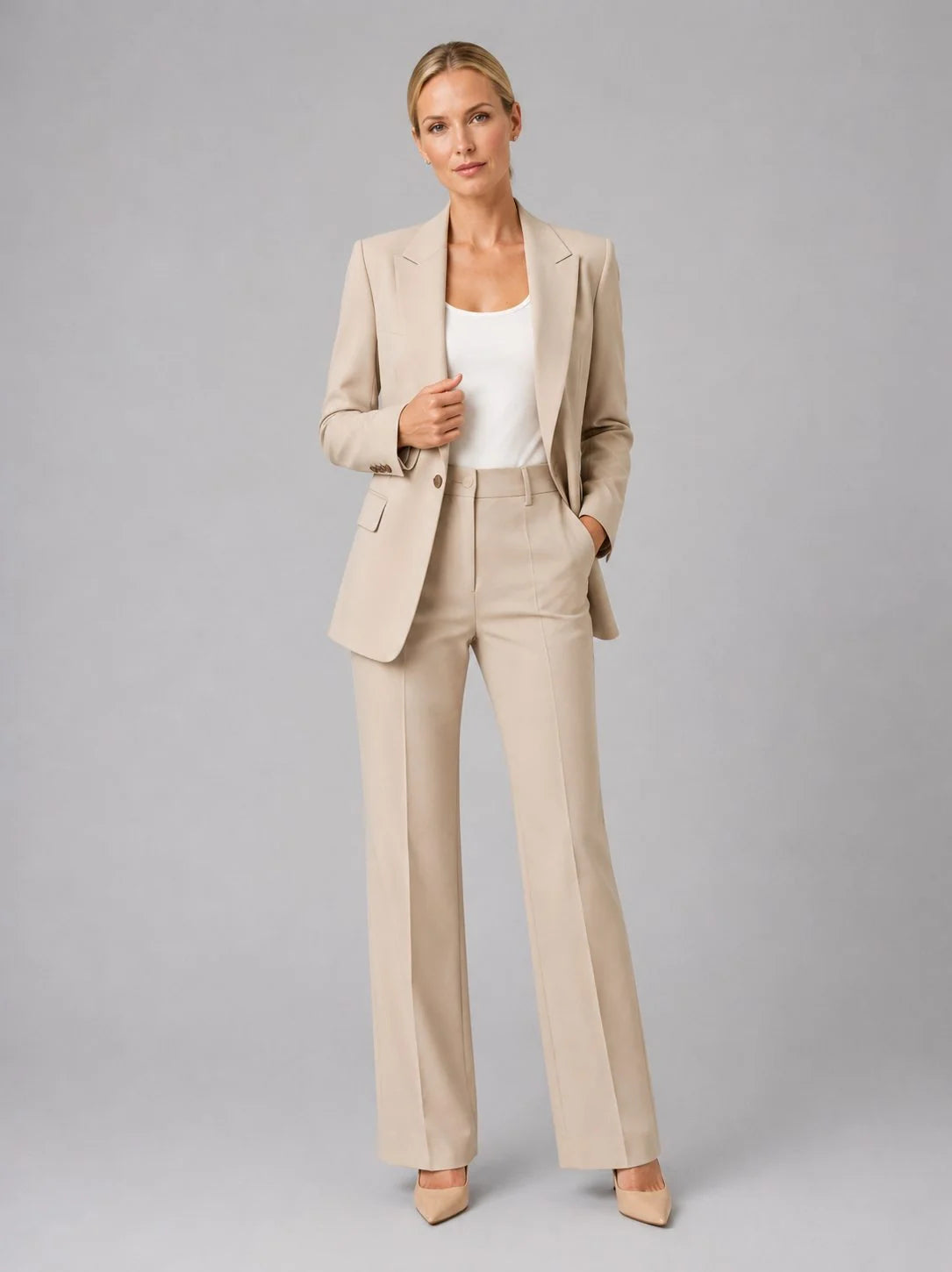 Full-length view of women's tailored suit set in pale blue worn with white camisole