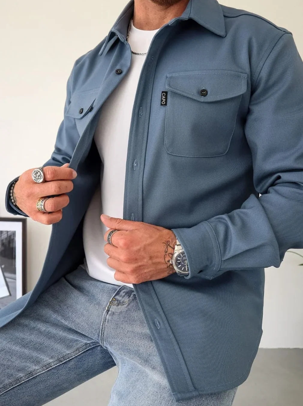 Detail shot of overshirt jacket chest pocket with button flap and smooth fabric finish