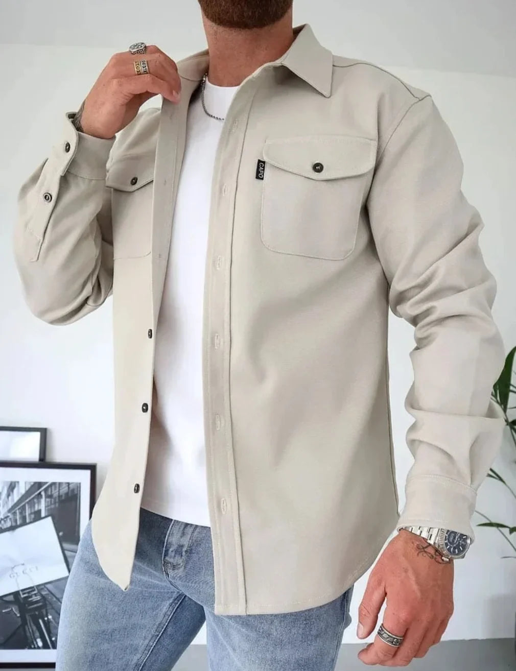 Back view of beige overshirt jacket showing structured shoulders and relaxed silhouette