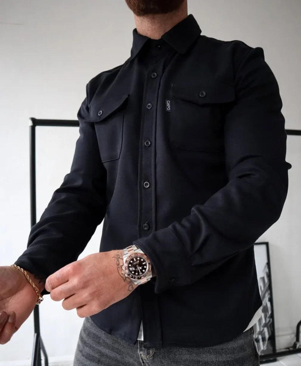 Man wearing overshirt jacket open over white tee demonstrating layering versatility