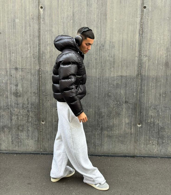 Side pocket detail on men's quilted puffer jacket with zip closure