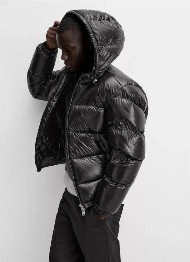 Close-up view of men's quilted puffer jacket showing horizontal channel stitching and zip closure