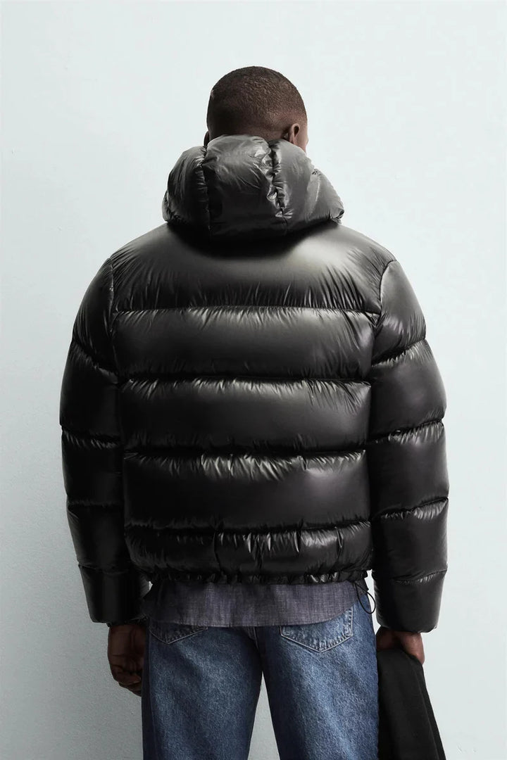 Side view of men's cropped puffer jacket with hooded neckline and relaxed fit
