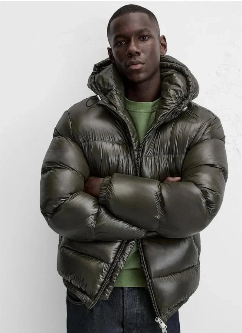 Men's black puffer jacket featuring zip pockets and insulated quilted construction