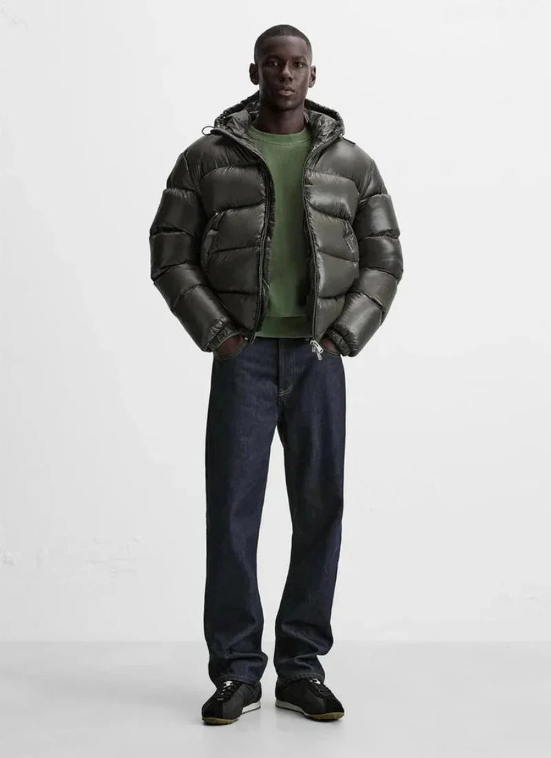 Full-length view of men's hooded puffer jacket paired with casual joggers and trainers