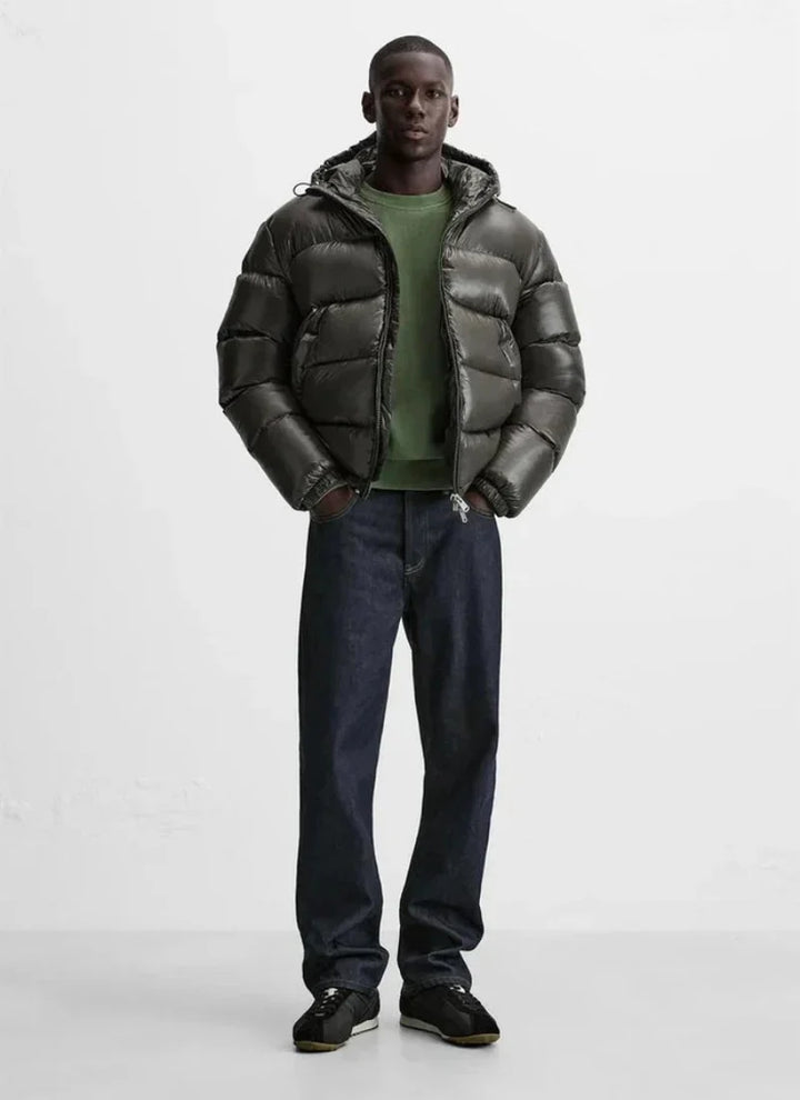 Full-length view of men's hooded puffer jacket paired with casual joggers and trainers