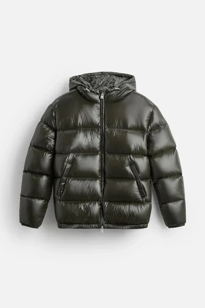 Men's quilted puffer jacket in black showing cropped length and relaxed silhouette