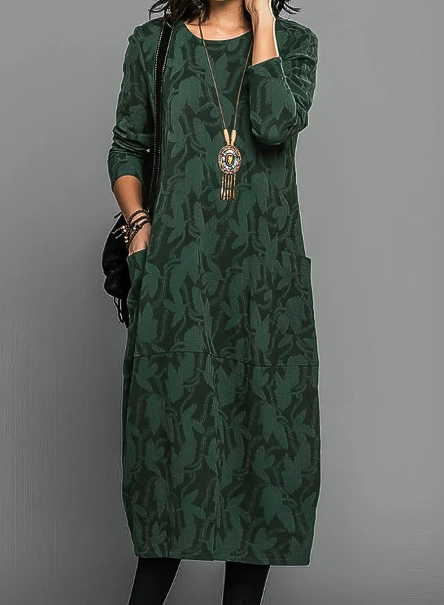 Jacquard midi dress in forest green with tonal pattern and long sleeves worn with statement necklace
