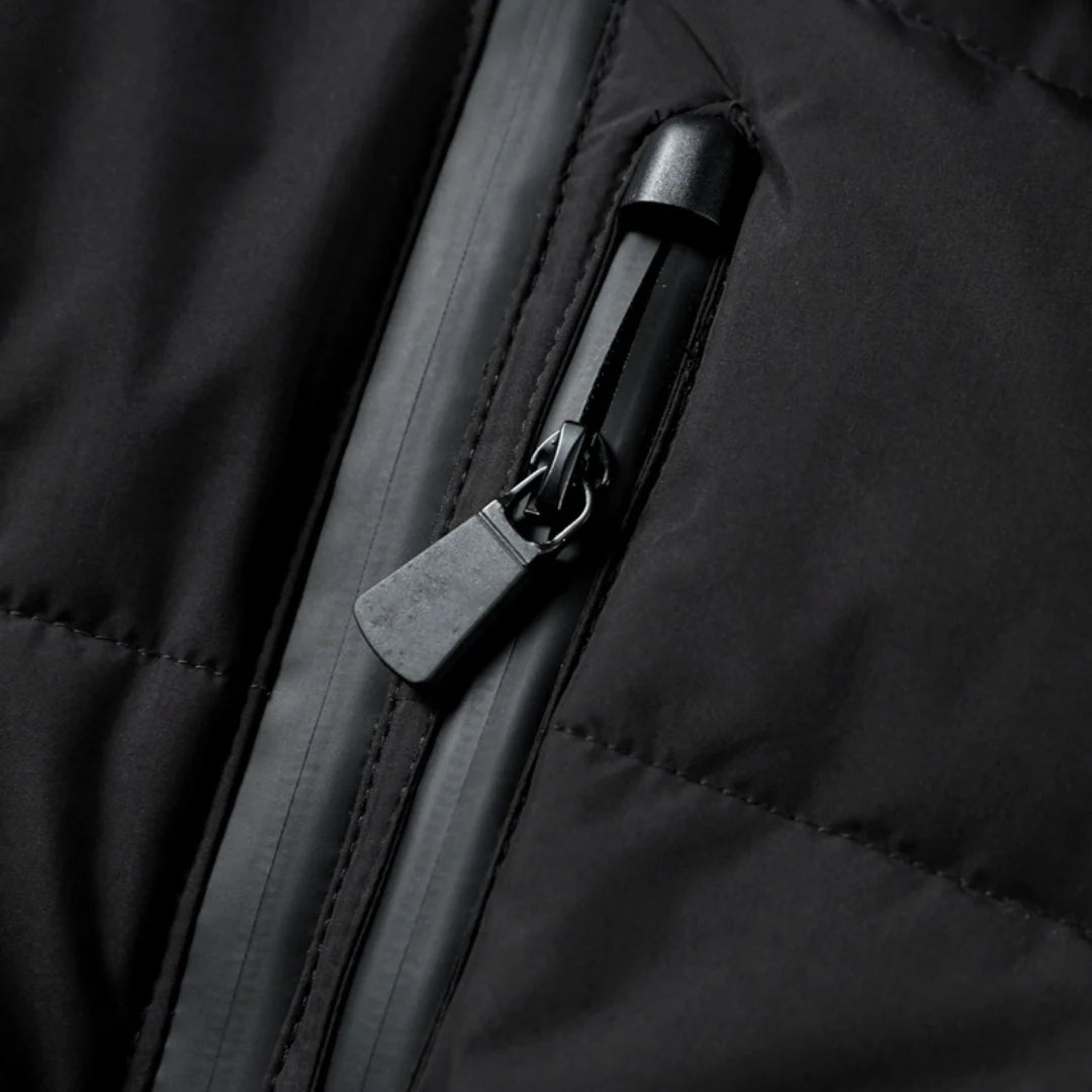 Detail of quilted puffer jacket with snap-button shoulder detailing and zip pockets