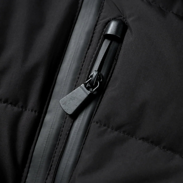 Detail of quilted puffer jacket with snap-button shoulder detailing and zip pockets