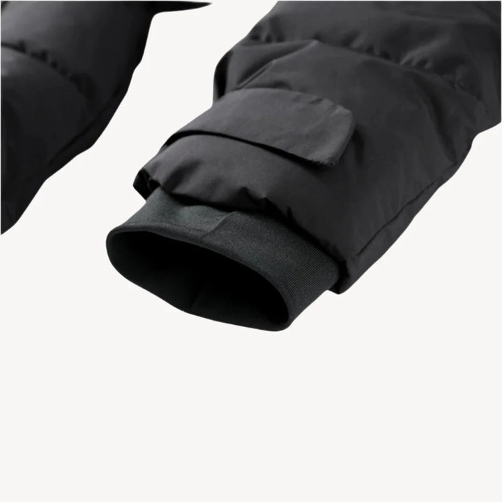 Close-up of belted puffer jacket showing funnel neck and insulated quilted construction