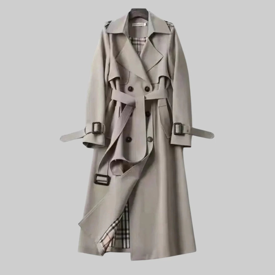 Beige women's trench coat with waist belt and traditional buckle detailing