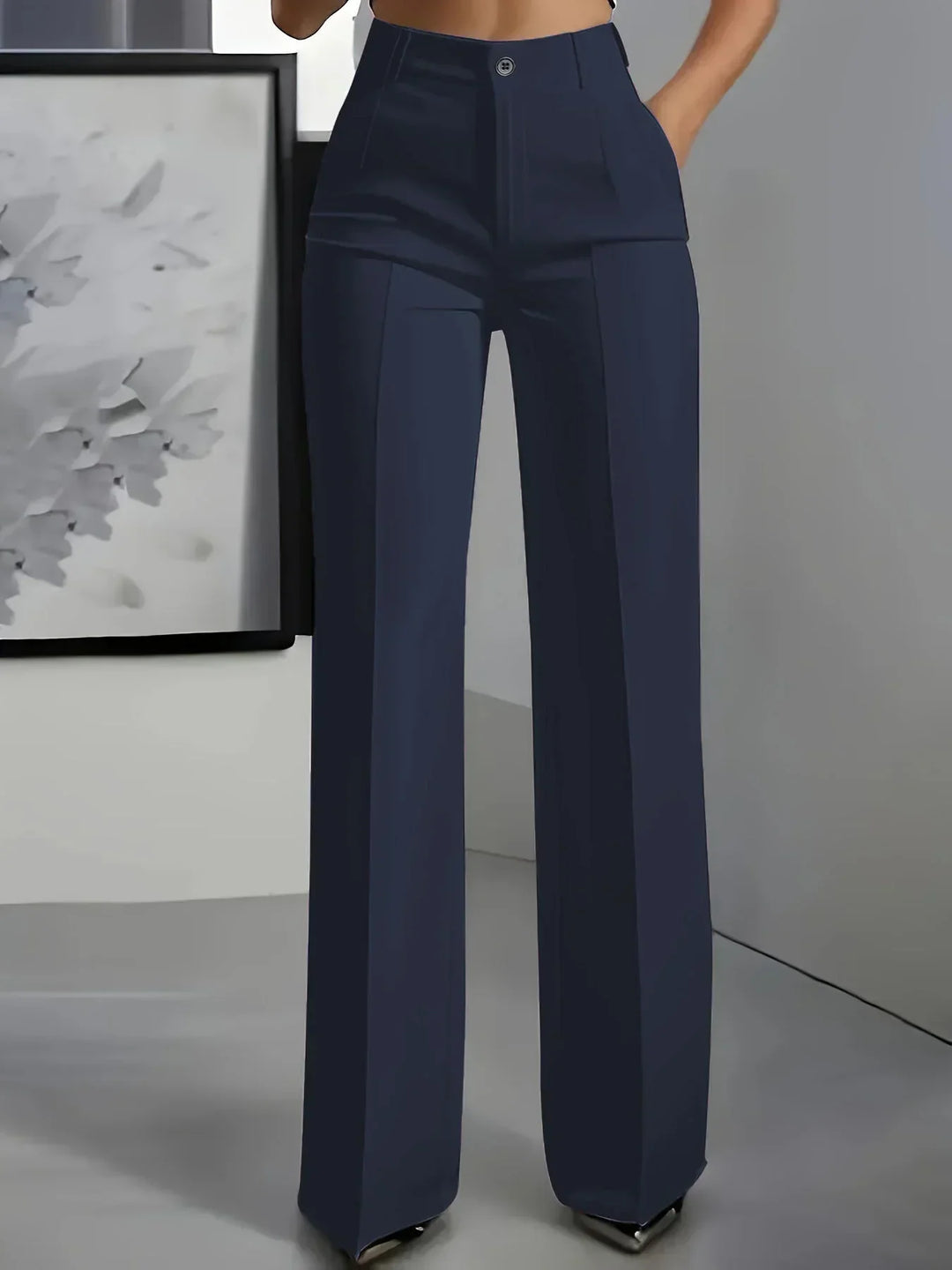 Side angle of women's wide leg trousers highlighting high rise and relaxed fit
